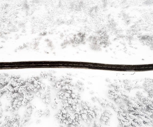 istock Mountain road in winter Drone view 924907676