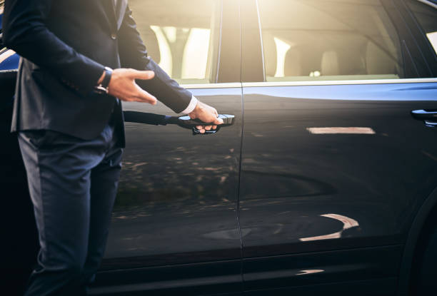 Your ride has arrived Cropped shot of a well dressed and unrecognizable man opening a car door vehicle door stock pictures, royalty-free photos & images