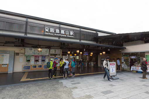Kyoto, Japan - November 21, 2015: Passengers at Arashiyama Station in Kyoto, Japan. This station is operated by Hankyu Railway.
