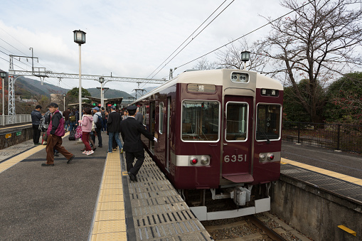Kyoto, Japan - November 21, 2015:  Passenger train parked at Arashiyama Station in Kyoto, Japan. This station is operated by Hankyu Railway.