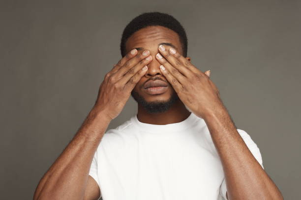 istock Black man covering eyes with hands 924914784