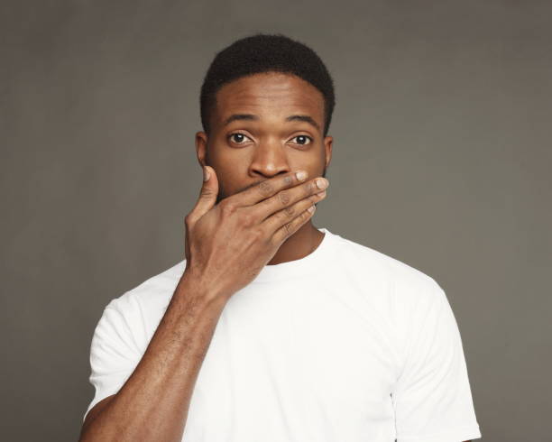 istock Black man covering mouth with hand 924914858