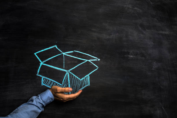 Man holding an open box drawn on blackboard