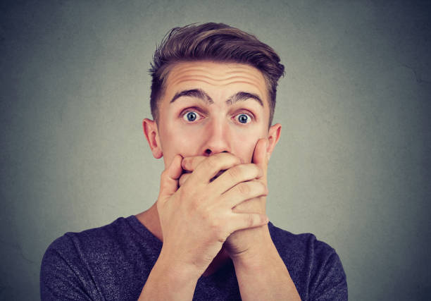 istock Portrait of a young anxious man looking shocked scared looking at camera 924915962