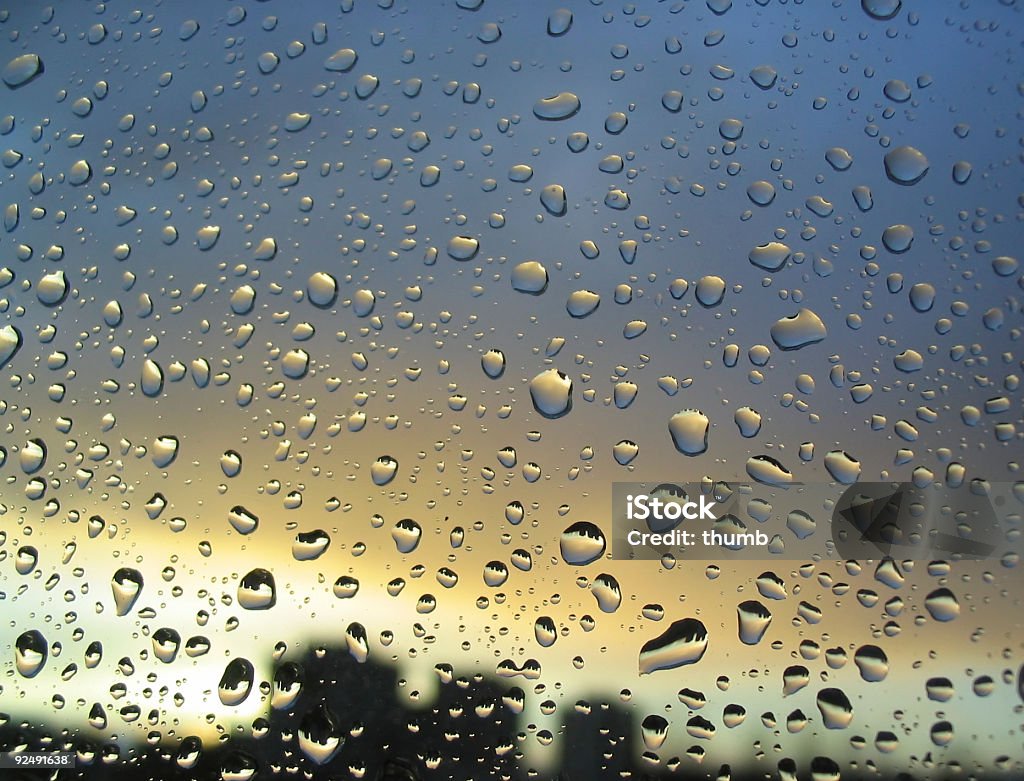 rain drops on the window, sunset in background,  Backgrounds Stock Photo