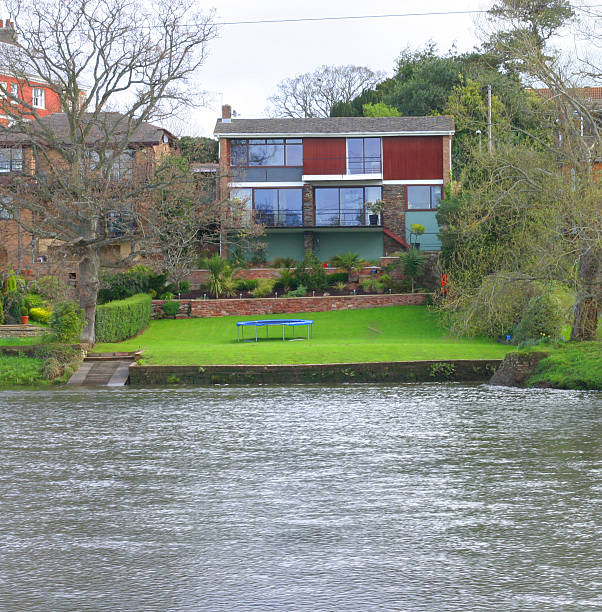 80's house by river stock photo
