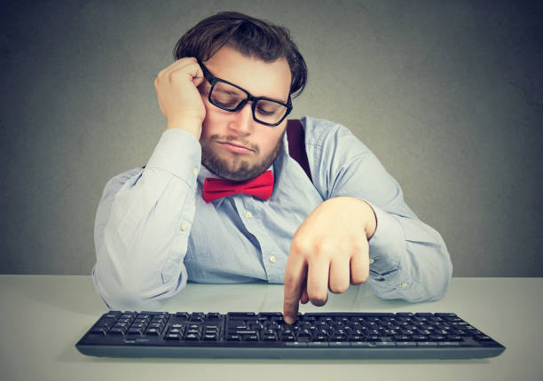 Lazy chunky office worker procrastinating Young obese man sitting at workplace and procrastinating being lazy and distracted. wasting time stock pictures, royalty-free photos & images