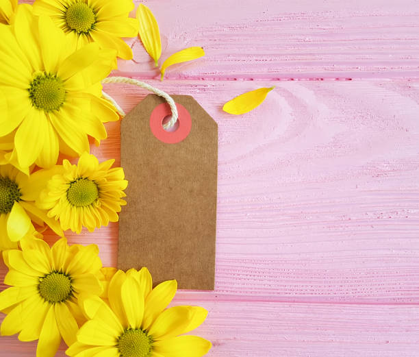 istock yellow chrysanthemum tag on a pink wooden background 924919288