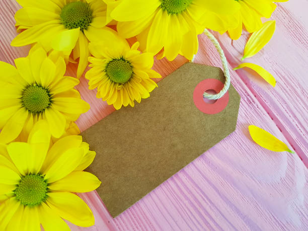 istock yellow chrysanthemum tag on a pink wooden background 924919772