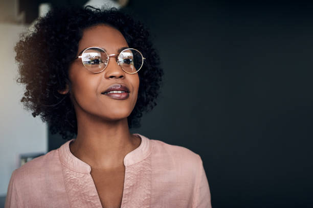 istock Confident African businesswoman standing alone in a modern office 924920096