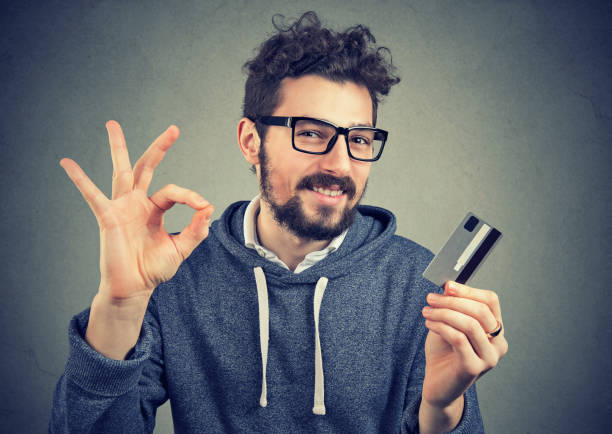 istock Satisfied man holding credit card 924920188