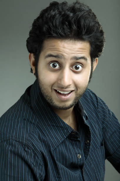 istock Portrait of surprised young Indian guy 924920260