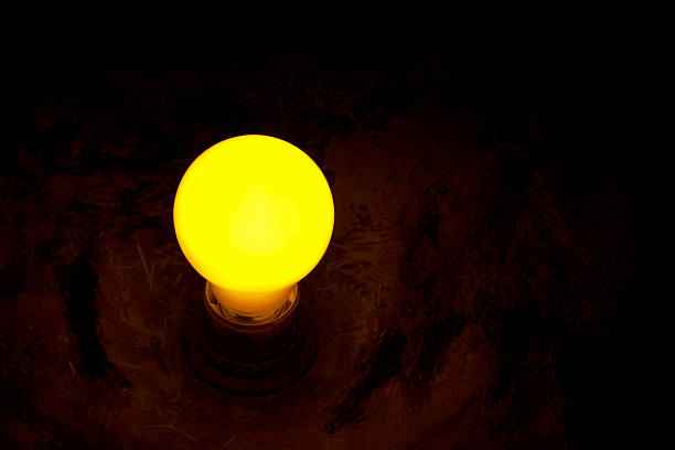 istock Yellow light bulb with a copper scatterer fading to black. 92492142