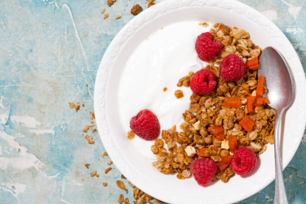 istock granola with dried apricots, fresh raspberries and yogurt for breakfast 924922462
