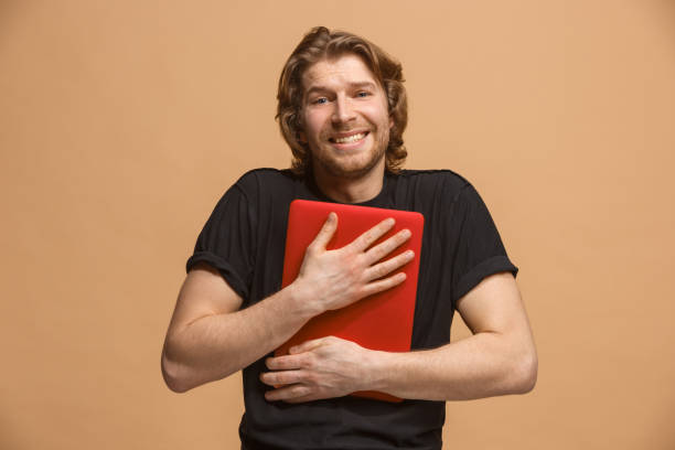 istock Businessman hugging laptop at studio 924923164