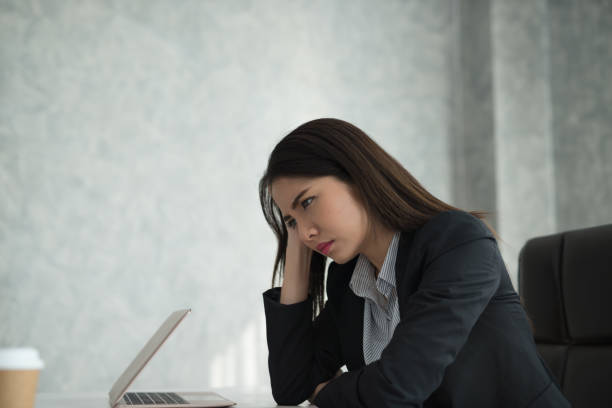 istock Young asian businesswoman feel stressed/worry/headache/disappoint during working while sit at office 924923458