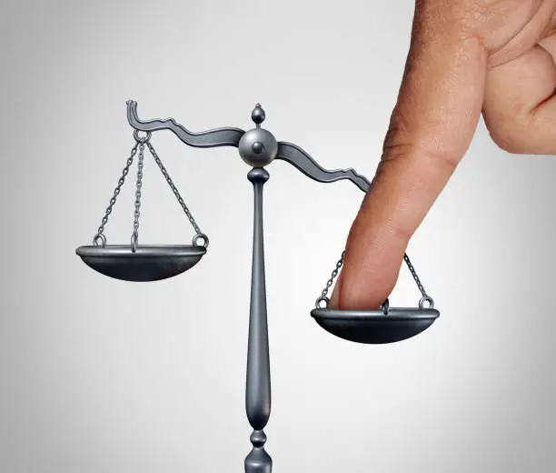 Tip the scales of justice concept as a the finger of a person illegaly influencing the legal system for an unfair advantage with 3D illustration elements.