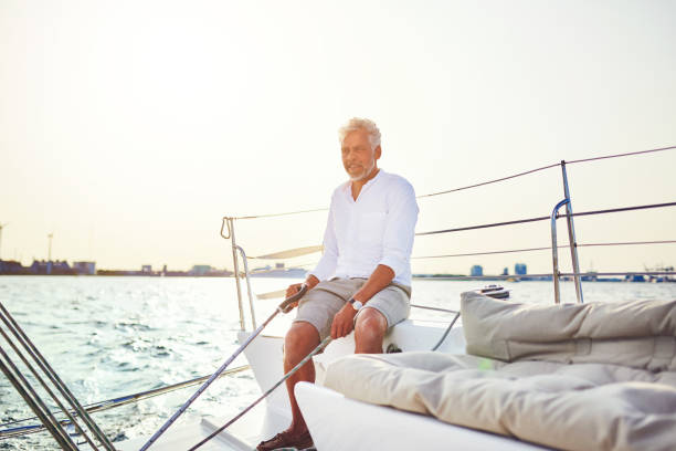 istock Mature man sitting on his boat enjoying a day sailing 924931580