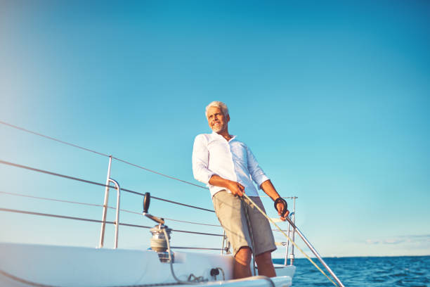 istock Smiling mature man enjoying a day sailing on the ocean 924932008