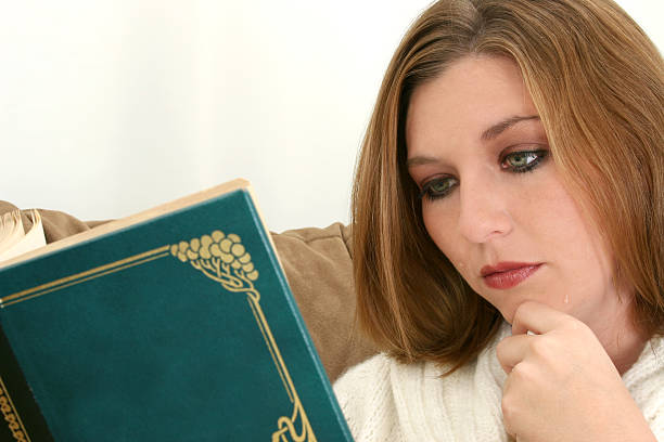istock Beautiful Woman Crying Over Novel 92493215