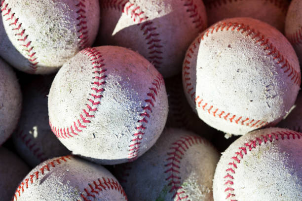 istock Basket of old baseballs and softballs on ground 924935338