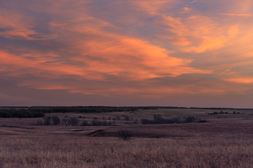 Daybreak as the sun rises in the distance at the Tallgrass Prairie Preserve in Pawhuska, Oklahoma, February 2018