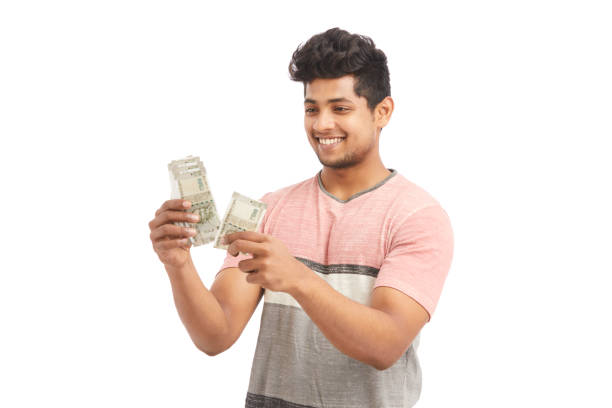 istock Cheerful young man counting Indian rupees 924935540