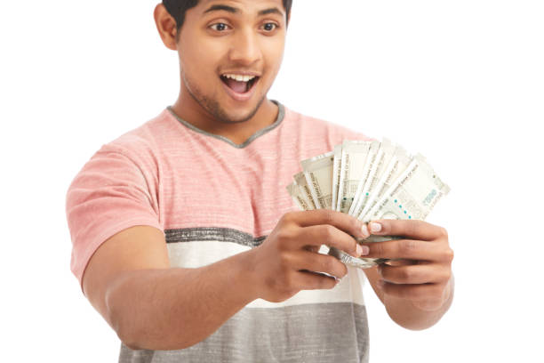 istock Surprised Indian young man with Indian rupees 924935566