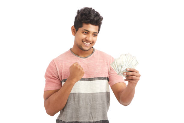 istock Successful happy young man cheering with Indian rupees 924935616