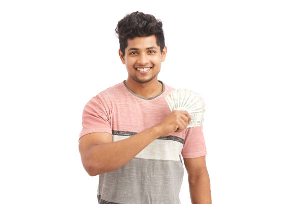 istock Attractive cheerful young man holding Indian rupees 924935650