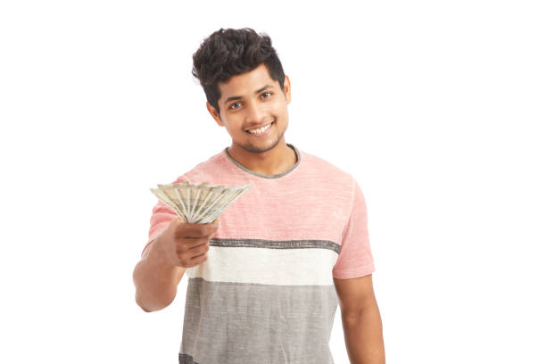 istock Cheerful young man offering Indian rupees 924935652