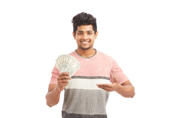 istock Attractive cheerful young man holding Indian rupees 924935654