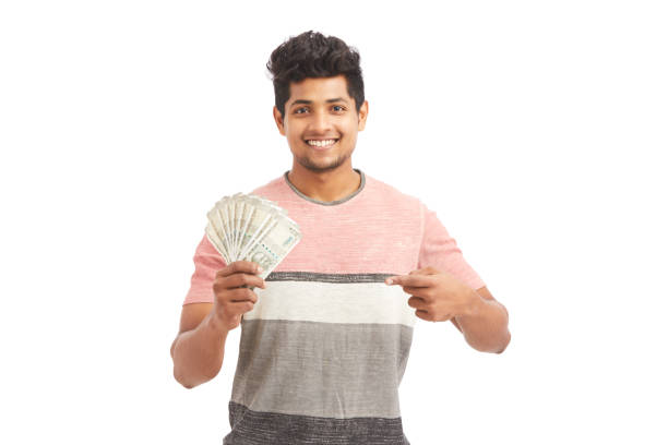 istock Attractive cheerful young man holding Indian rupees 924935662