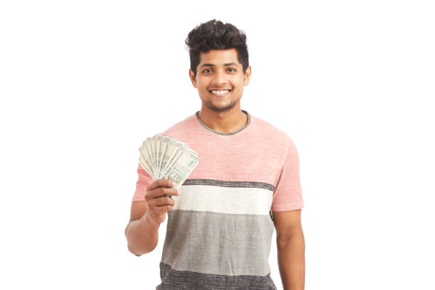 istock Attractive cheerful young man holding Indian rupees 924935672
