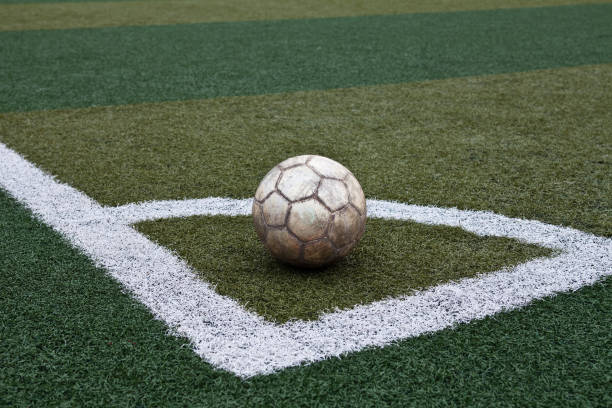 istock Old leather soccer ball on a green lawn 924935858