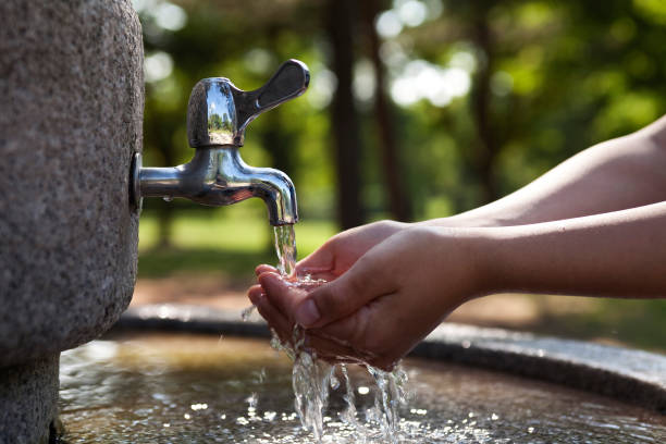istock Hand open for drinking tap water in asia 924936072