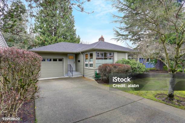 Small Grey Home Exterior With A Garage Stock Photo - Download Image Now - House, Small, Driveway