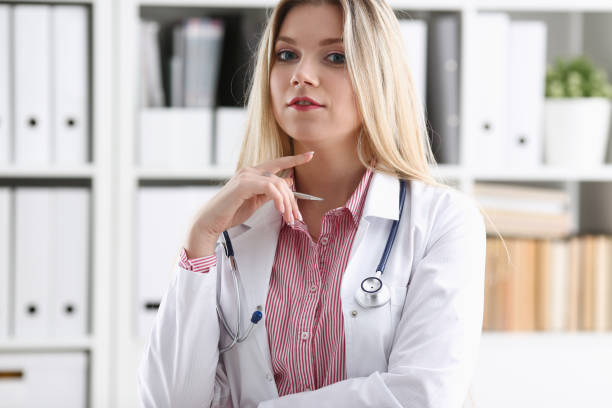 istock Beautiful smiling female doctor sit at workplace 924939272