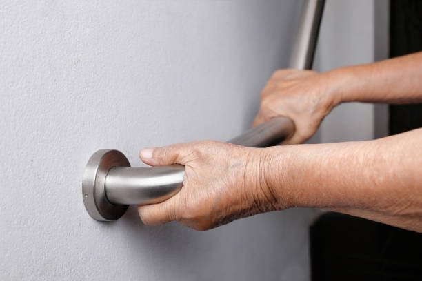 istock Elderly woman holding on handrail for safety walk steps 924939656