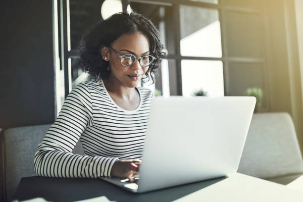 istock Young African woman sitting alone working on a laptop 924940206