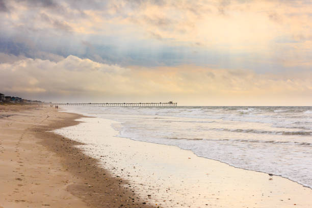 Emerald Isle Beach Beach and Bogue Inlet Fishing Pier at Emerald Isle, North Carolina. emerald isle north carolina stock pictures, royalty-free photos & images