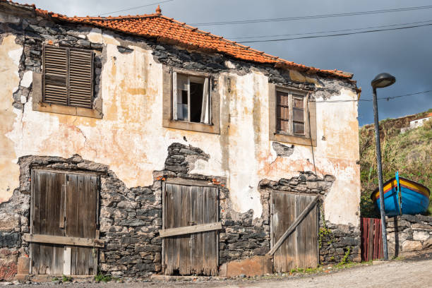 istock old abandoned house with wooden doors in Madeira with boat 924943348