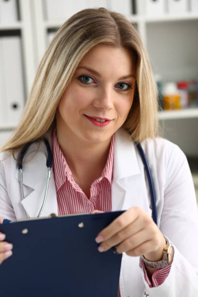 istock Beautiful smiling female doctor hold clipboard 924946916