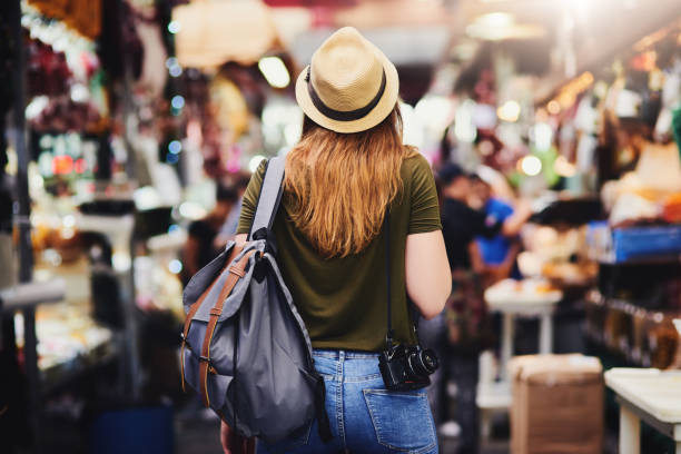 Moving on to the next area of wonder Rearview shot of an unrecognizable woman wearing a hat and walking through a busy market outside during the day ariel west bank stock pictures, royalty-free photos & images