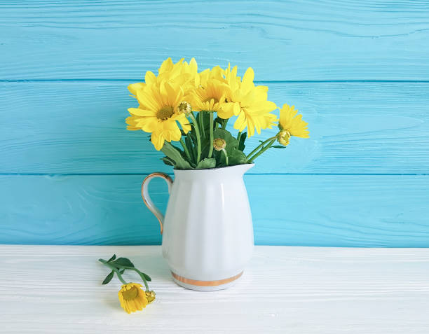 istock yellow chrysanthemum vase on white and blue 924951332