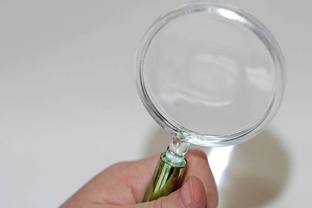 magnifying glass in hand stock photo