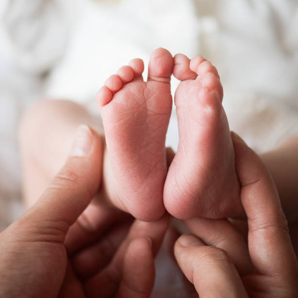 istock feet for newborns in mother's hands 924954164