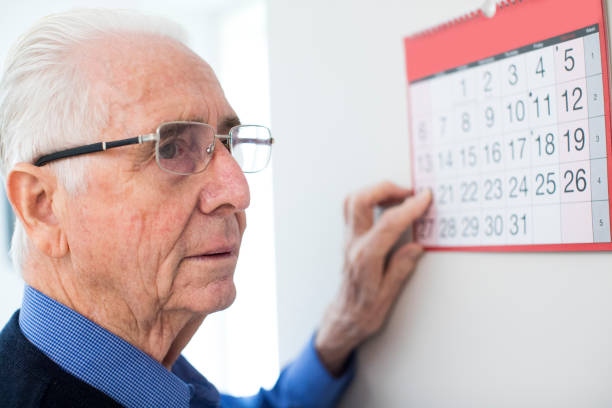istock Confused Senior Man With Dementia Looking At Wall Calendar 924954252
