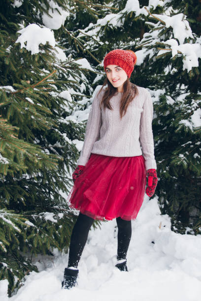 Woman having fun in winter forest