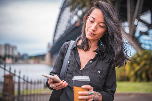 istock Asian woman using phone in Sydney 924955344